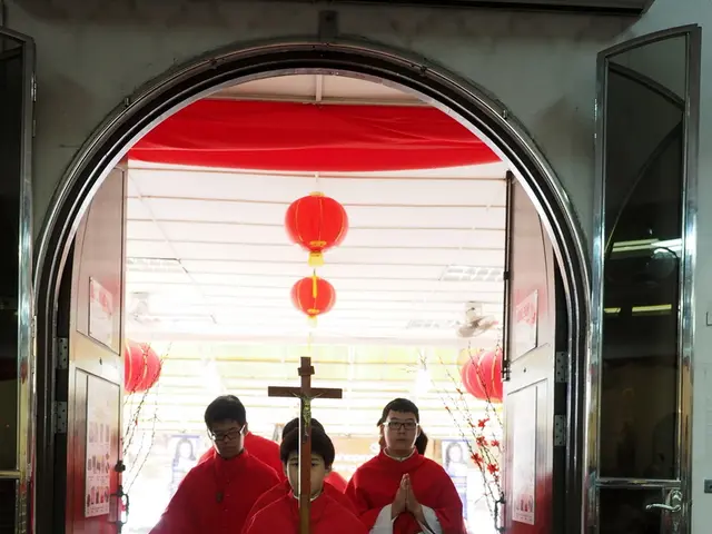 The picture is taken in a cathedral. In the center of the picture there are people walking holding...