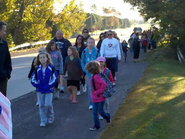 In the image we can see there are many people and children's walking, they are wearing clothes and...